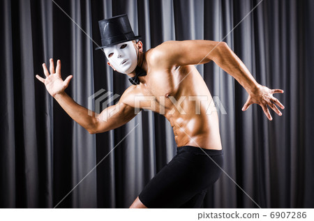 Muscular actor with mask against curtain Muscular actor with mask against curtain 6907286