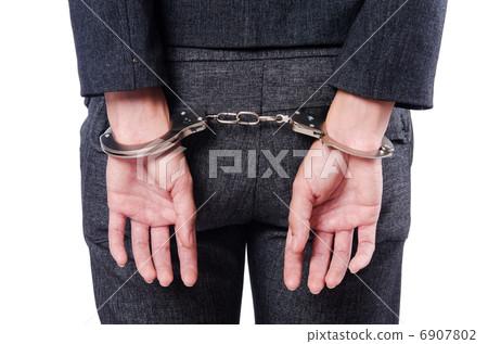 Female businesswoman with handcuffs on white 6907802