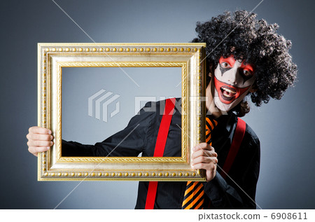 Clown with picture frames in studio Clown with picture frames in studio 6908611