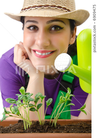 Girl watering plants on white 6909475