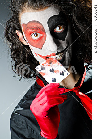 Joker with face mask in studio 6910242