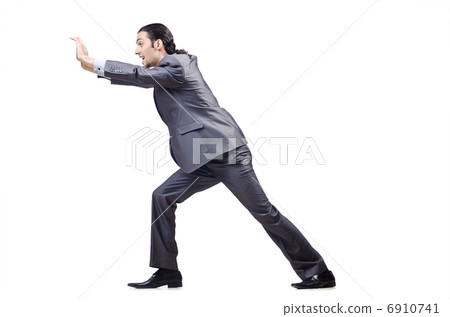 Young businessman pushing invisible obstacles Young businessman pushing invisible obstacles 6910741