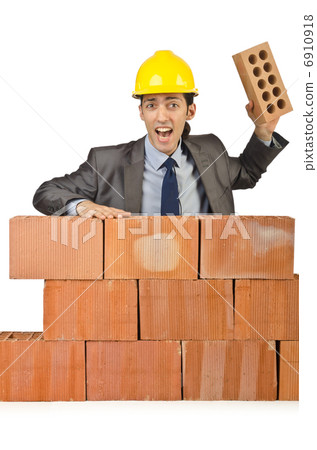 Businessman with bricks on white 6910918