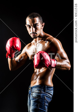 Young man with boxing gloves 6911516