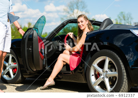 Young couple with cabriolet in summer on day trip Young couple with cabriolet in summer on day trip 6912337