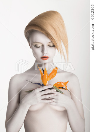Bodypainting. Enigmatic Gorgeous Woman with Strelitzia flower in hands. Painted Skin Bodypainting. Enigmatic Gorgeous Woman with Strelitzia flower in hands. Painted Skin 6912365