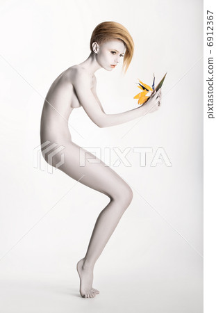 Imaginary. Expressive Undressed Woman in Fantastic Graceful Pose. Statue with Flower Imaginary. Expressive Undressed Woman in Fantastic Graceful Pose. Statue with Flower 6912367