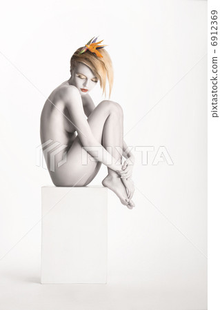 Fantasy. Harmony. Beauty Muse sitting over White Background. Bodyart - Platinum Painted Skin Fantasy. Harmony. Beauty Muse sitting over White Background. Bodyart - Platinum Painted Skin 6912369