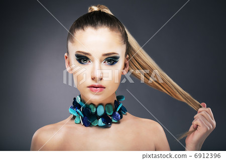 Treatment. Woman holding Tips of her long faint Hair in hand 6912396