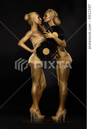 Futurism. Creativity. Glossy Golden Women with Vinyl Record over Black. Shiny Gilded Bodyart Futurism. Creativity. Glossy Golden Women with Vinyl Record over Black. Shiny Gilded Bodyart 6912397