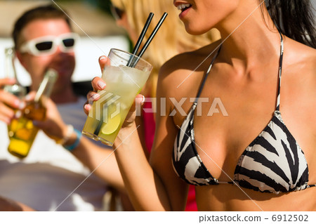 People at beach drinking having a party People at beach drinking having a party 6912502