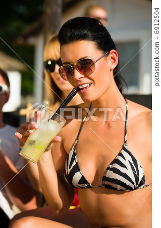 People at beach drinking having a party 6912504