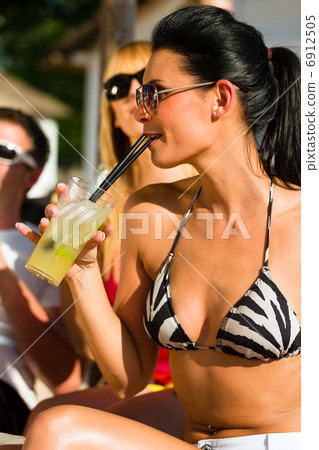 People at beach drinking having a party 6912505