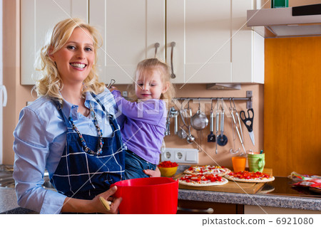 Family - mother and child baking pizza 6921080