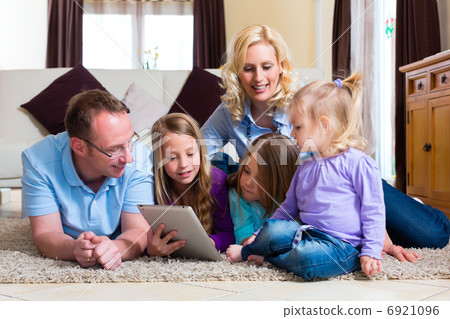 Family playing with Tablet computer at home 6921096