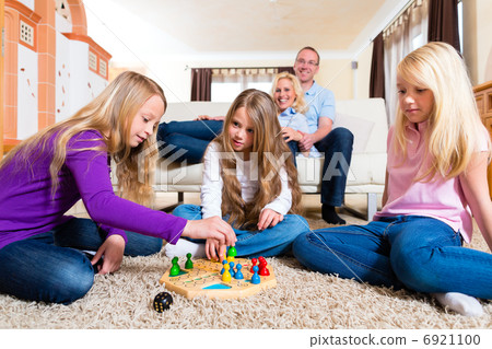 Family playing board game at home Family playing board game at home 6921100