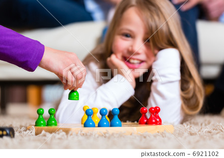 Family playing board game at home 6921102
