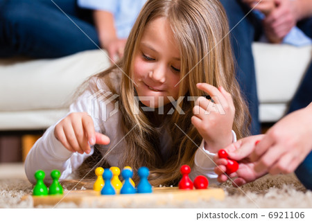 Family playing board game at home 6921106