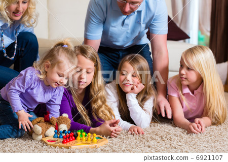 Family playing board game at home 6921107