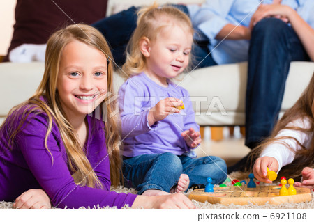 Family playing board game at home Family playing board game at home 6921108
