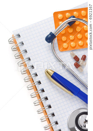 stethoscope with pills and notebook 6921167