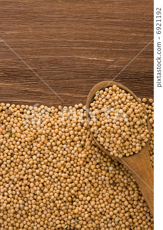 mustard and spoon on wood 6921192
