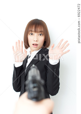 A woman aimed at a gun 6922472