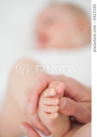 Feet of a baby being touched Feet of a baby being touched 6922589