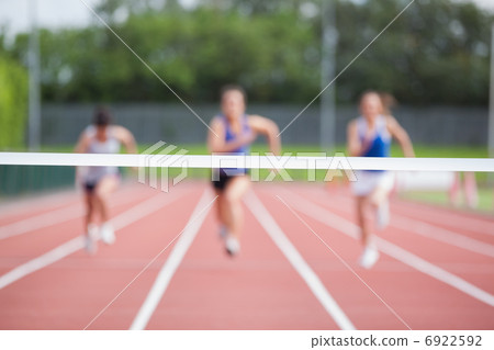 Athletes running towards finish line Athletes running towards finish line 6922592