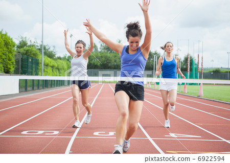 Athlete celebrates race win at finish line Athlete celebrates race win at finish line 6922594