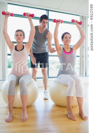 Trainer teaching class on exercise ball Trainer teaching class on exercise ball 6922599