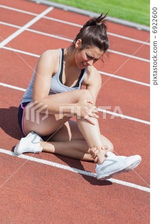 Female runner with ankle injury Female runner with ankle injury 6922600