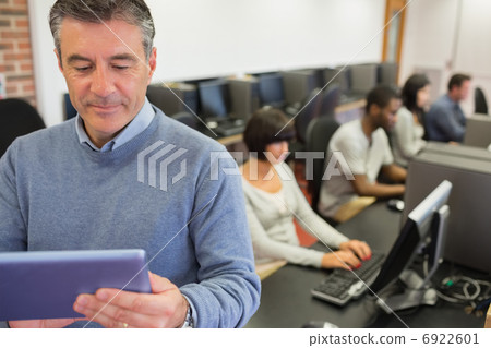 Teacher standing holding a tablet PC 6922601