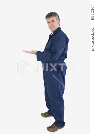 Mature technician gesturing Mature technician gesturing 6922864