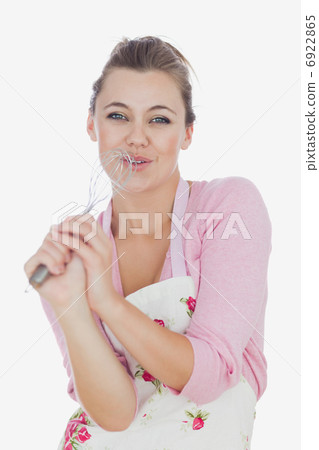 Maid using wire whisk as microphone while signing Maid using wire whisk as microphone while signing 6922865
