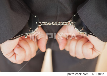 Attrested businessman clenching fists 6923044