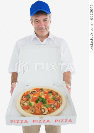 Mature delivery man holding pizza 6923045