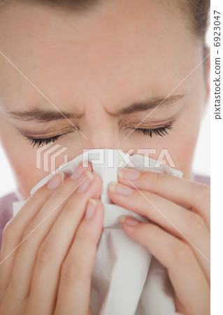 Woman blowing her nose Woman blowing her nose 6923047