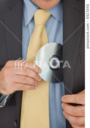 Businessman putting CD in his pocket 6923048