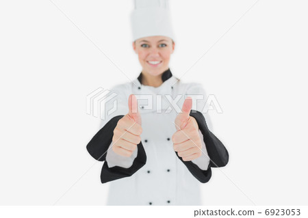 Happy female chef gesturing thumbs up Happy female chef gesturing thumbs up 6923053