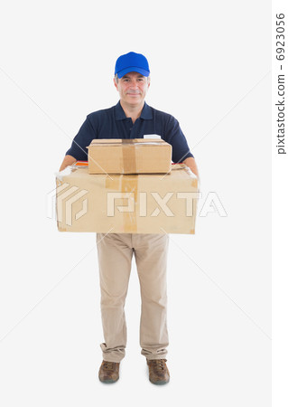 Delivery man carrying stack of cardboard packages Delivery man carrying stack of cardboard packages 6923056