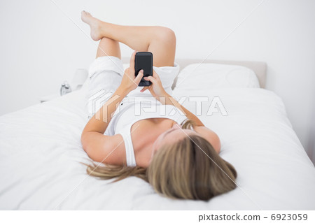 Calm woman touching her phone Calm woman touching her phone 6923059