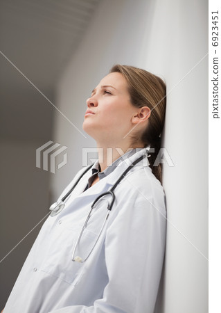 Thinking doctor sitting on a hallway Thinking doctor sitting on a hallway 6923451