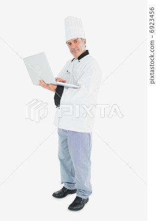 Male chef using laptop Male chef using laptop 6923456