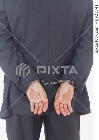Rear view of businessman with handcuffs 6923541