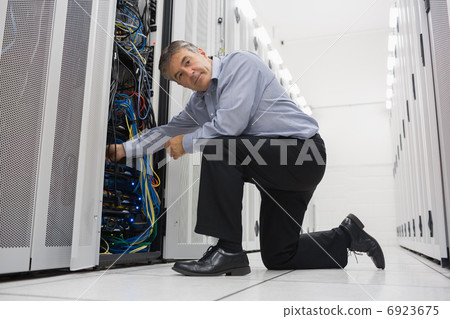 Man fixing server wires Man fixing server wires 6923675
