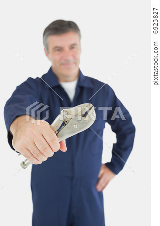 Male mechanic holding vise grip 6923827