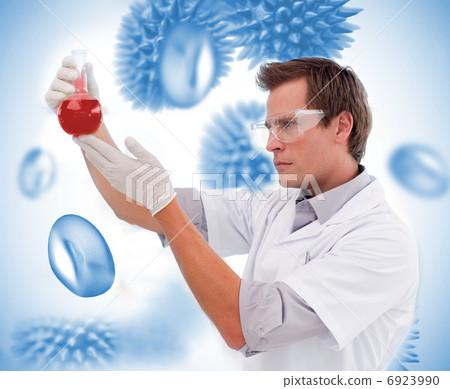 Scientist looking at beaker 6923990
