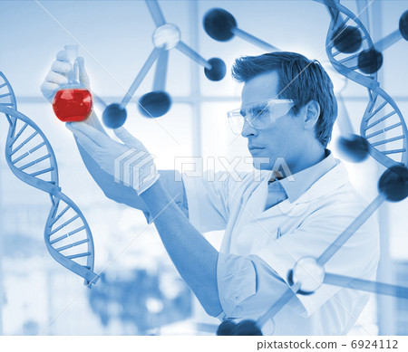 Scientist examining a beaker 6924112