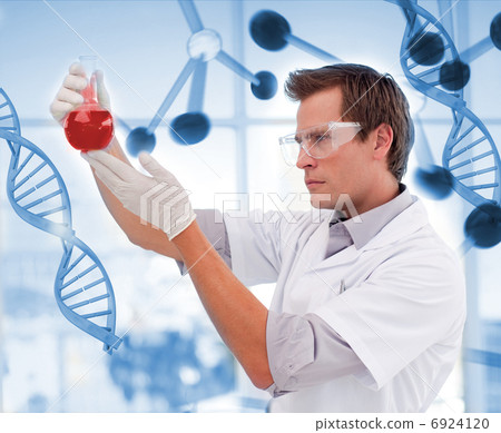 Scienctist examining a red liquid 6924120
